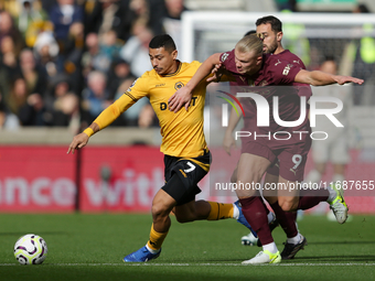 Andre of Wolves battles for possession with Erling Haaland of Manchester City during the Premier League match between Wolverhampton Wanderer...