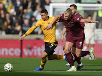 Andre of Wolves battles for possession with Erling Haaland of Manchester City during the Premier League match between Wolverhampton Wanderer...