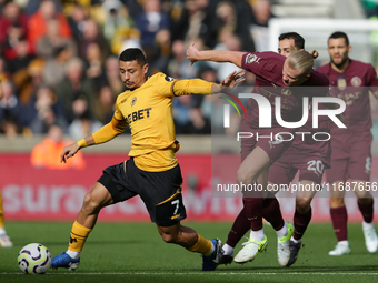 Andre of Wolves battles for possession with Erling Haaland of Manchester City during the Premier League match between Wolverhampton Wanderer...