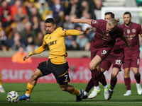 Andre of Wolves battles for possession with Erling Haaland of Manchester City during the Premier League match between Wolverhampton Wanderer...