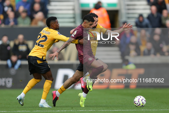 Savinho of Manchester City is in action with Nelson Semedo and Rayan Ait-Nouri of Wolves during the Premier League match between Wolverhampt...