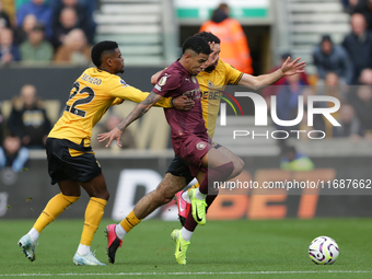 Savinho of Manchester City is in action with Nelson Semedo and Rayan Ait-Nouri of Wolves during the Premier League match between Wolverhampt...