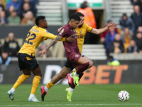 Savinho of Manchester City is in action with Nelson Semedo and Rayan Ait-Nouri of Wolves during the Premier League match between Wolverhampt...