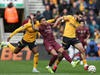 Savinho of Manchester City is in action with Nelson Semedo and Rayan Ait-Nouri of Wolves during the Premier League match between Wolverhampt...