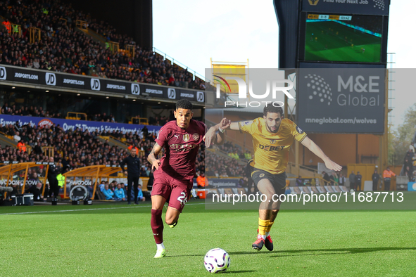 Savinho of Manchester City (L) is in action with Rayan Ait-Nouri of Wolves during the Premier League match between Wolverhampton Wanderers a...