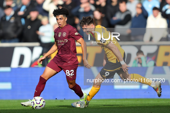 Rico Lewis of Manchester City and Jorgen Strand Larsen of Wolves are in action during the Premier League match between Wolverhampton Wandere...