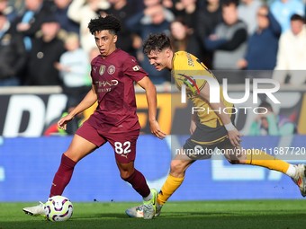 Rico Lewis of Manchester City and Jorgen Strand Larsen of Wolves are in action during the Premier League match between Wolverhampton Wandere...