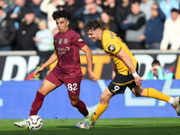 Rico Lewis of Manchester City and Jorgen Strand Larsen of Wolves are in action during the Premier League match between Wolverhampton Wandere...