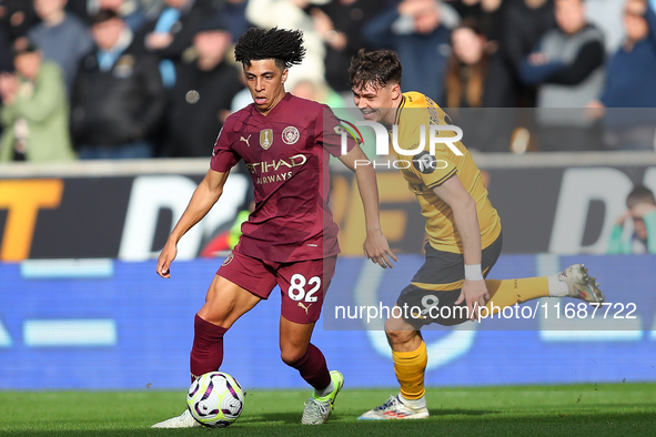 Rico Lewis of Manchester City and Jorgen Strand Larsen of Wolves are in action during the Premier League match between Wolverhampton Wandere...