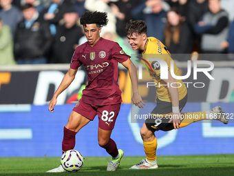 Rico Lewis of Manchester City and Jorgen Strand Larsen of Wolves are in action during the Premier League match between Wolverhampton Wandere...