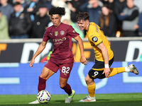 Rico Lewis of Manchester City and Jorgen Strand Larsen of Wolves are in action during the Premier League match between Wolverhampton Wandere...