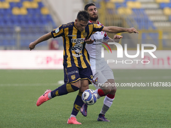 Andrea Adorante of SS Juve Stabia competes for the ball with Matteo Bianchetti of Cremonese during the Serie B match between SS Juve Stabia...