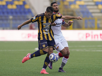 Andrea Adorante of SS Juve Stabia competes for the ball with Matteo Bianchetti of Cremonese during the Serie B match between SS Juve Stabia...