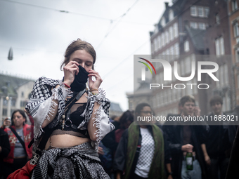 ADEV participants dance through the streets of Amsterdam, Netherlands, on October 19, 2024.  On Saturday, October 19, 2024, the ADEV (Amster...