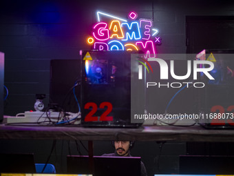 An Iranian man plays a video game at a gaming venue at night in the historical city of Tabriz, Iran, on October 18, 2024, amid global concer...