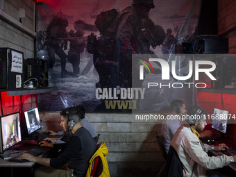 Iranian youths play video games at a gaming venue at night in Tabriz, Iran, on October 18, 2024, amid global concerns about war between Iran...