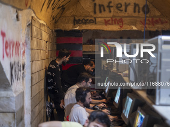 Iranian youths play video games at a gaming venue at night in Tabriz, Iran, on October 18, 2024, amid global concerns about war between Iran...