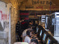 Iranian youths play video games at a gaming venue at night in Tabriz, Iran, on October 18, 2024, amid global concerns about war between Iran...