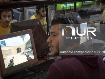 Iranian youths play video games at a gaming venue at night in Tabriz, Iran, on October 18, 2024, amid global concerns about war between Iran...