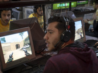 Iranian youths play video games at a gaming venue at night in Tabriz, Iran, on October 18, 2024, amid global concerns about war between Iran...