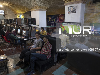 Iranian youths play video games at a gaming venue at night in Tabriz, Iran, on October 18, 2024, amid global concerns about war between Iran...