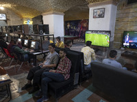 Iranian youths play video games at a gaming venue at night in Tabriz, Iran, on October 18, 2024, amid global concerns about war between Iran...