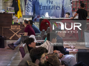 Iranian youths play video games at a gaming venue at night in Tabriz, Iran, on October 18, 2024, amid global concerns about war between Iran...