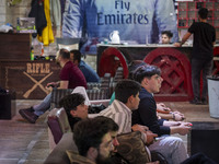 Iranian youths play video games at a gaming venue at night in Tabriz, Iran, on October 18, 2024, amid global concerns about war between Iran...