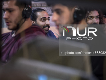 Iranian youths play video games at a gaming venue at night in Tabriz, Iran, on October 18, 2024, amid global concerns about war between Iran...