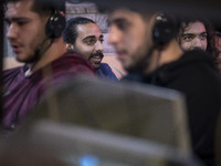 Iranian youths play video games at a gaming venue at night in Tabriz, Iran, on October 18, 2024, amid global concerns about war between Iran...