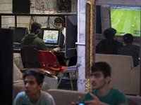 Iranian youths play video games at a gaming venue at night in Tabriz, Iran, on October 18, 2024, amid global concerns about war between Iran...