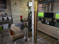 Iranian youths play FIFA at a gaming venue at night in the historical city of Tabriz, Iran, on October 18, 2024, amid global concerns about...