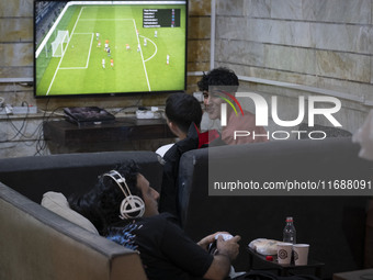 Iranian youths play FIFA at a gaming venue at night in the historical city of Tabriz, Iran, on October 18, 2024, amid global concerns about...