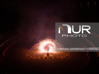 A Zoolians artist captivates the audience with a fiery performance during the closing show of '????????'?????: Arcanes' in the Arles arenas....