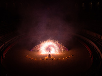 A Zoolians artist captivates the audience with a fiery performance during the closing show of '????????'?????: Arcanes' in the Arles arenas....