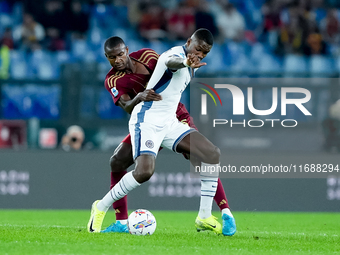 Evan Ndicka of AS Roma and Marcus Thuram of FC Internazionale compete for the ball during the Serie A Enilive match between AS Roma and FC I...