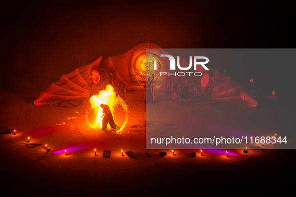 A Zoolians artist captivates the audience with a fiery performance during the closing show of '????????'?????: Arcanes' in the Arles arenas....