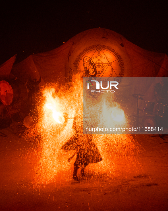 A Zoolians artist captivates the audience with a fiery performance during the closing show of '????????'?????: Arcanes' in the Arles arenas....