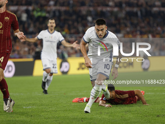 Inter's Lautaro Martinez celebrates after scoring their first goal during the Serie A soccer match between AS Roma and Inter FC at Stadio Ol...