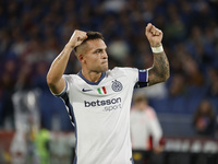 Inter's Lautaro Martinez celebrates after scoring their first goal during the Serie A soccer match between AS Roma and Inter FC at Stadio Ol...