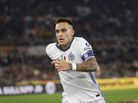 Inter's Lautaro Martinez celebrates after scoring their first goal during the Serie A soccer match between AS Roma and Inter FC at Stadio Ol...