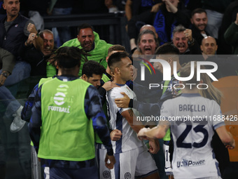 Inter's Lautaro Martinez celebrates after scoring their first goal during the Serie A soccer match between AS Roma and Inter FC at Stadio Ol...