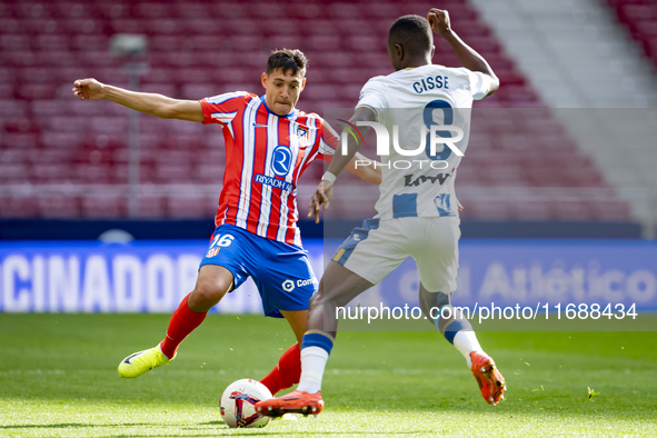 Nahuel Molina of Atletico de Madrid (L) is in action with the ball against Seydouba Cisse of CD Leganes (R) during the La Liga EA Sports 202...