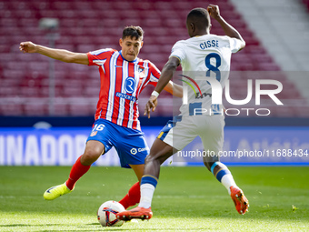 Nahuel Molina of Atletico de Madrid (L) is in action with the ball against Seydouba Cisse of CD Leganes (R) during the La Liga EA Sports 202...