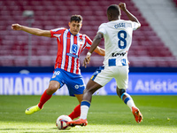 Nahuel Molina of Atletico de Madrid (L) is in action with the ball against Seydouba Cisse of CD Leganes (R) during the La Liga EA Sports 202...