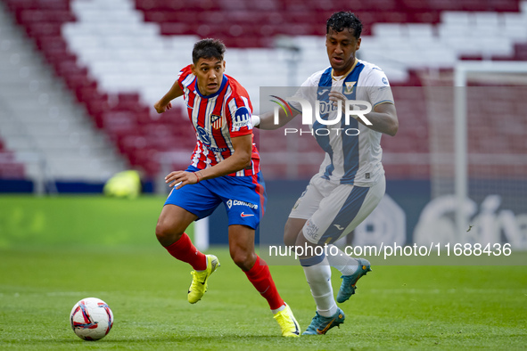 Nahuel Molina of Atletico de Madrid (L) is in action with the ball against Renato Tapia of CD Leganes (R) during the La Liga EA Sports 2024/...