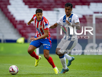 Nahuel Molina of Atletico de Madrid (L) is in action with the ball against Renato Tapia of CD Leganes (R) during the La Liga EA Sports 2024/...