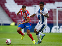 Nahuel Molina of Atletico de Madrid (L) is in action with the ball against Renato Tapia of CD Leganes (R) during the La Liga EA Sports 2024/...