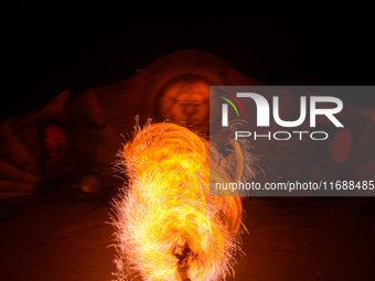 A Zoolians artist captivates the audience with a fiery performance during the closing show of '????????'?????: Arcanes' in the Arles arenas....