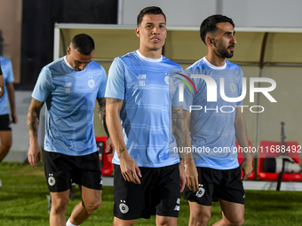 Andres Villa (C) and Ali Asadalla Thaimn (R) of Al Sadd FC look on before the training session at Jassim Bin Hamad Stadium in Doha, Qatar, o...